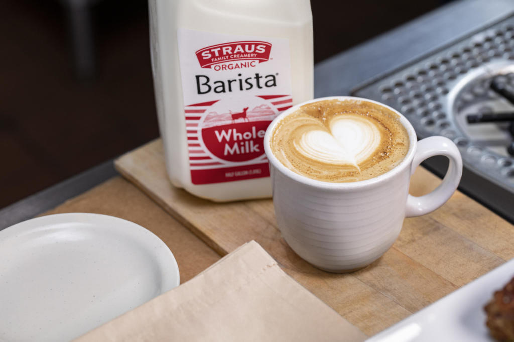 straus organic whole barista milk next to latte