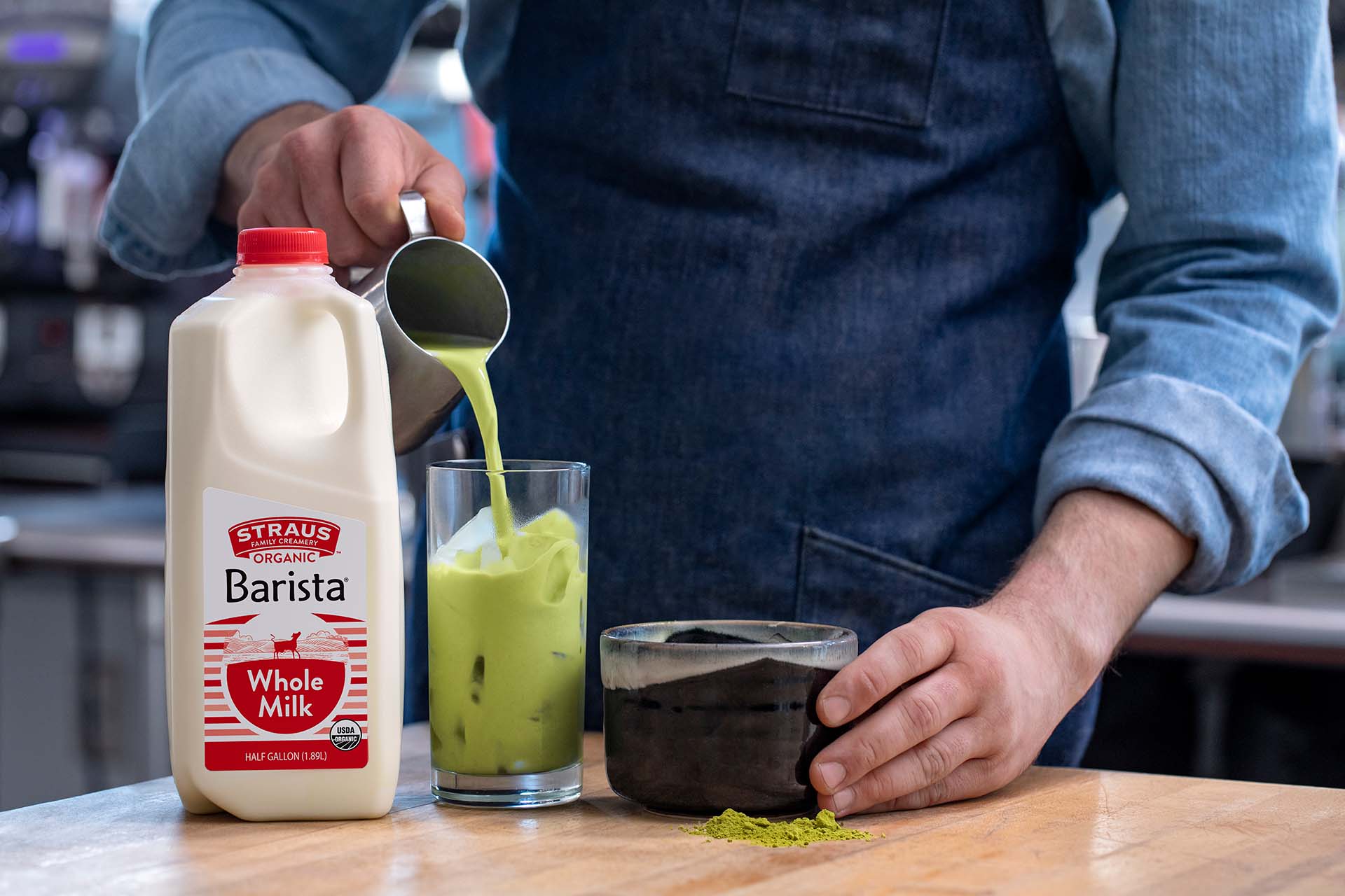 barista making iced matcha beverage with straus milk