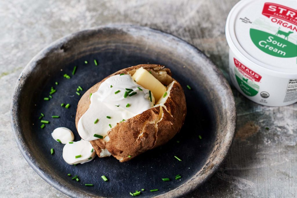 organic sour cream on baked potato