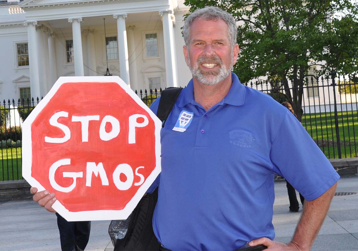 albert straus holding "Stop GMOs" sign