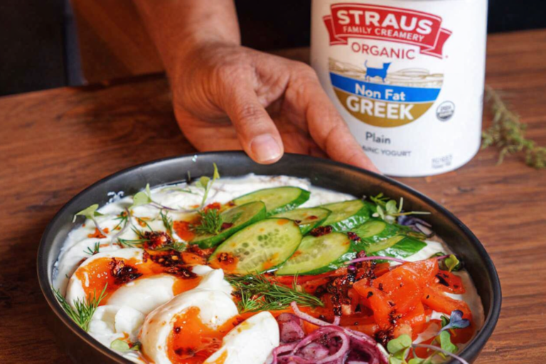 Savory Greek yogurt bowl made with Straus Organic Non Fat Greek Yogurt topped with cucumber, tomato, pickled red onion, chili oil, and fresh dill